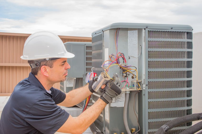 Technician is checking outdoor air conditioner unit